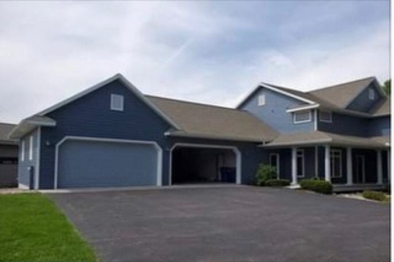 Freshly painted charcoal home with crisp white trim