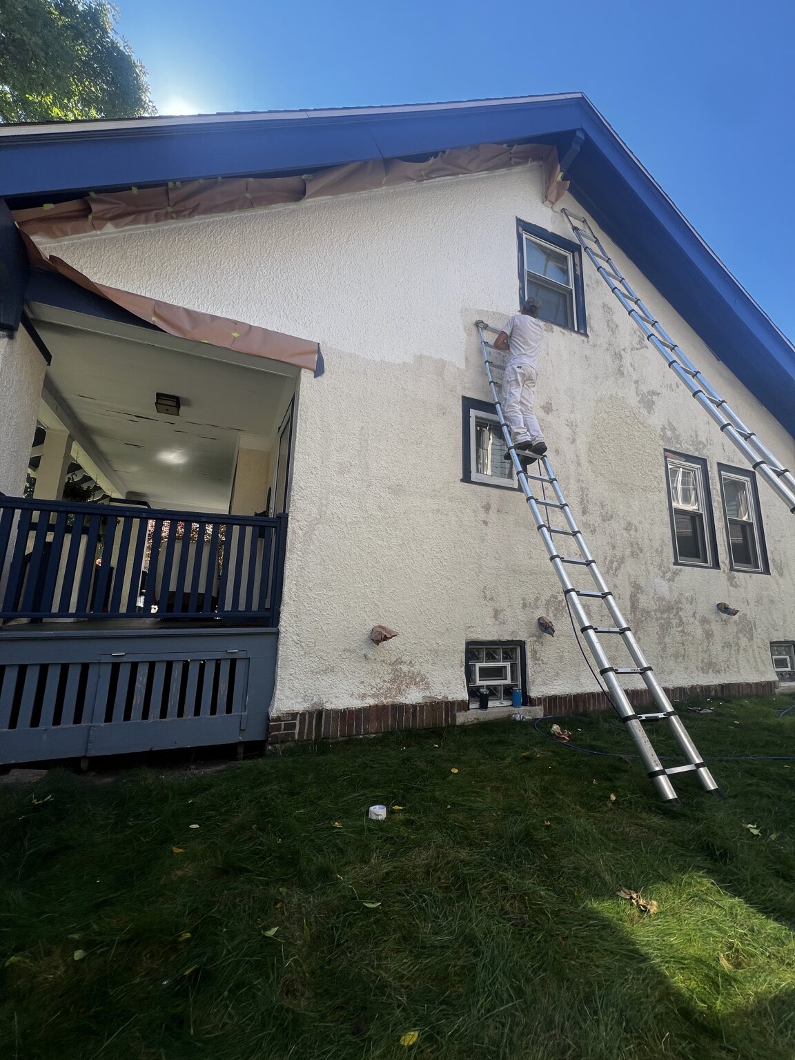Painter working on an exterior wall