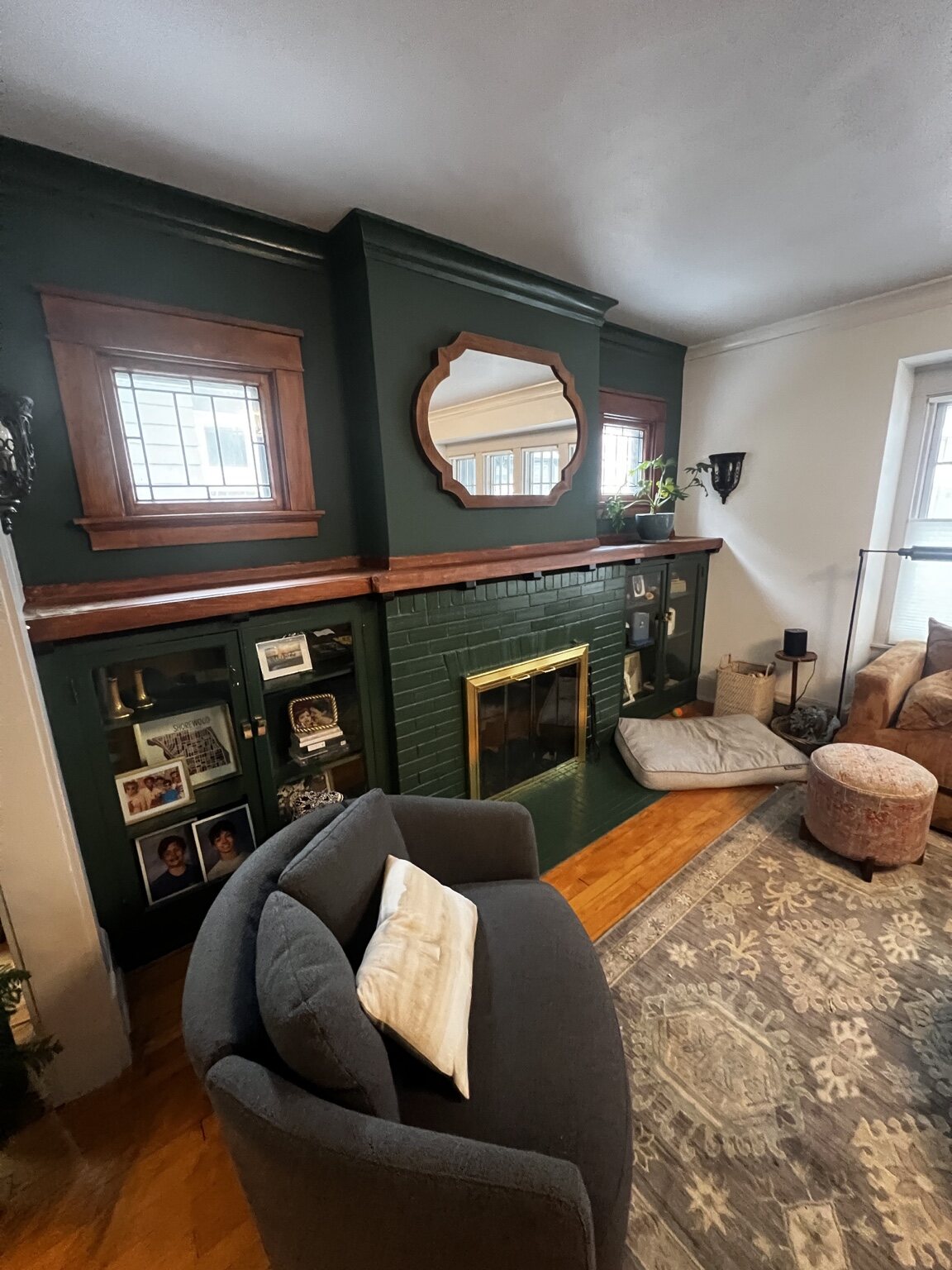 Dark green painted fireplace and built-in shelving