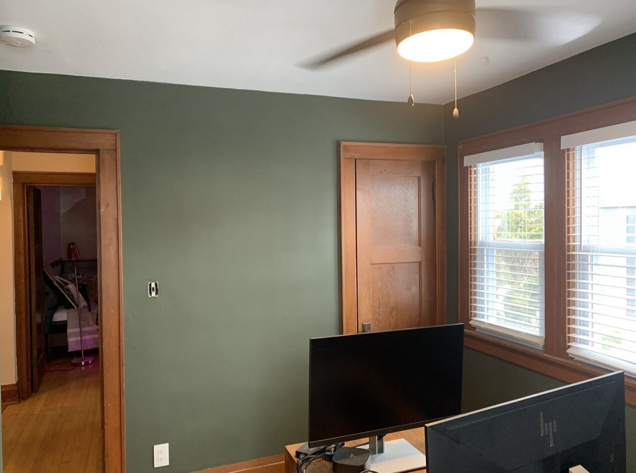 Sage green interior walls with natural wood trim
